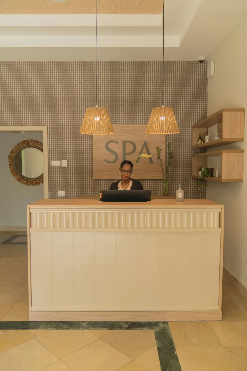 Spa reception with attendant behind the desk at Bahia Principe Escape Ambar.
