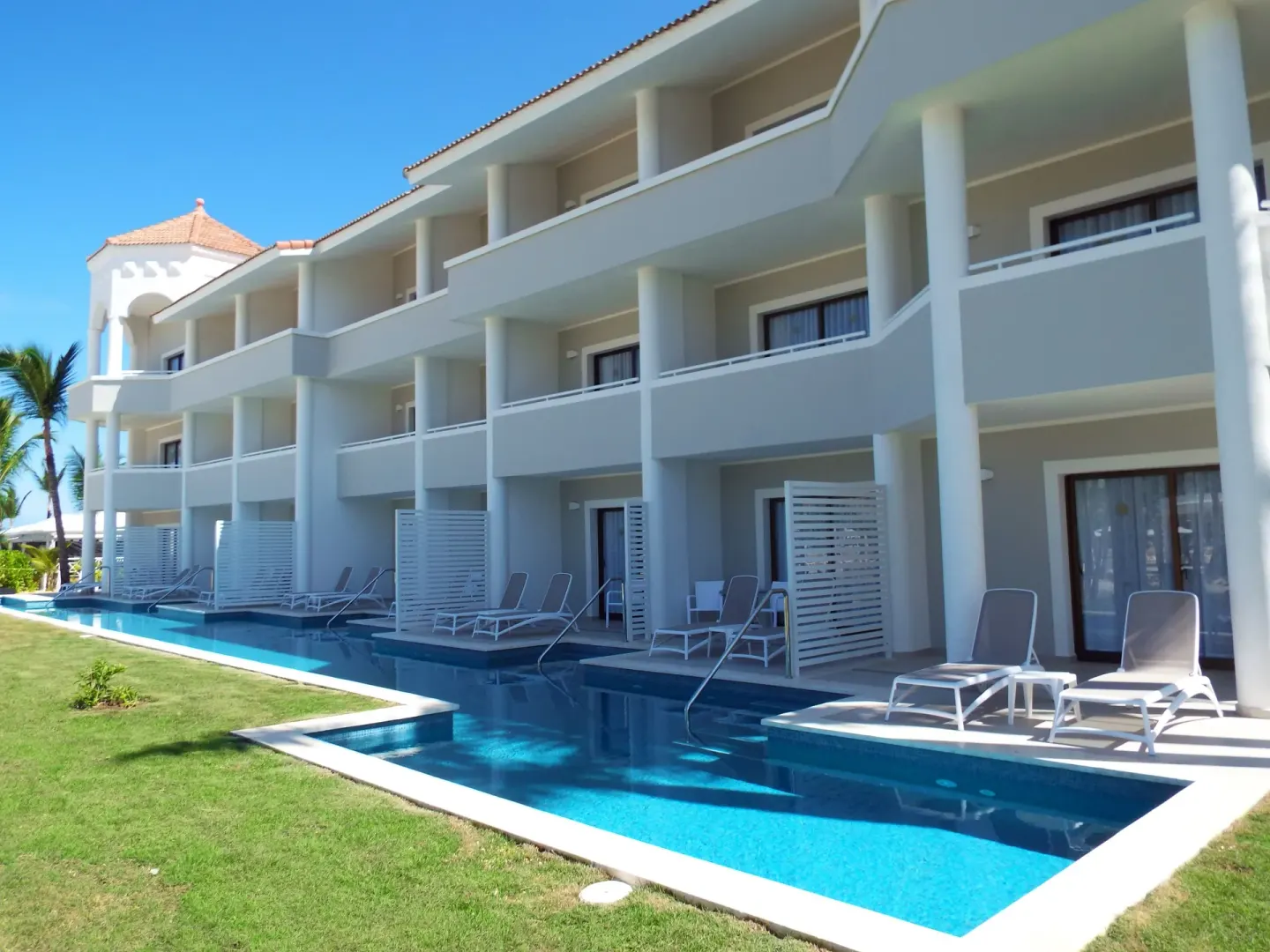 Swim-up guest room patios with loungers at Bahia Principe Escape Ambar.