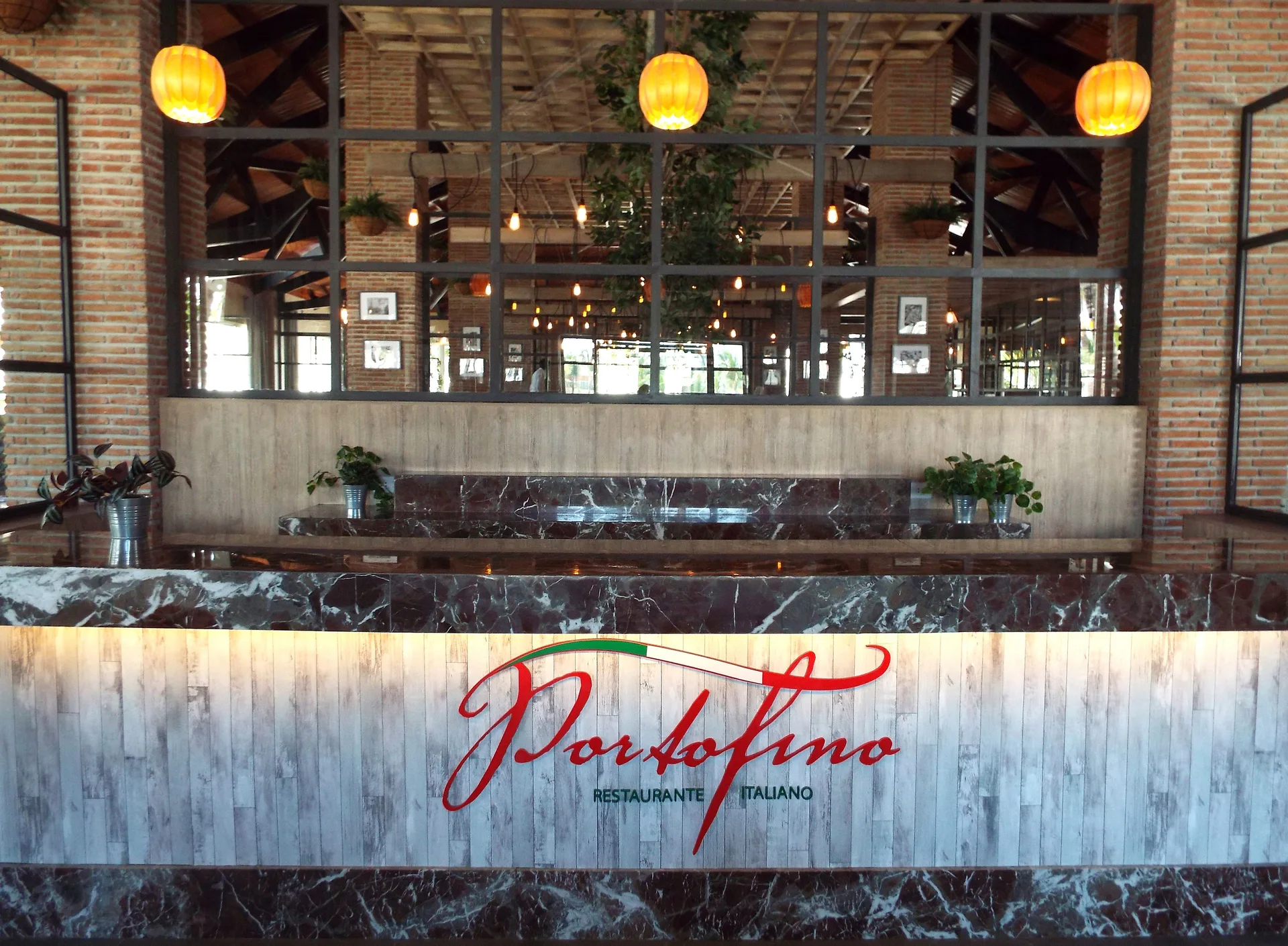 Portofino reception counter with restaurant sign at Bahia Principe Escape Ambar.