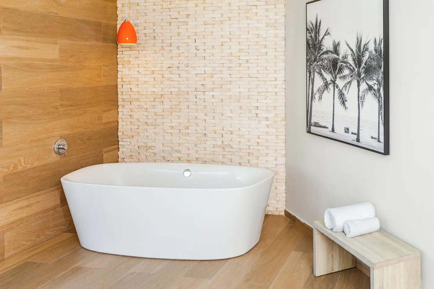 Freestanding tub with palm artwork in a Junior Suite Corner Swim Up at Bahia Principe Escape Ambar.