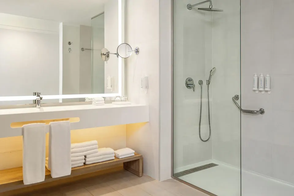 Junior Suite deluxe bathroom vanity and glass shower at Bahia Principe Escape Ambar.