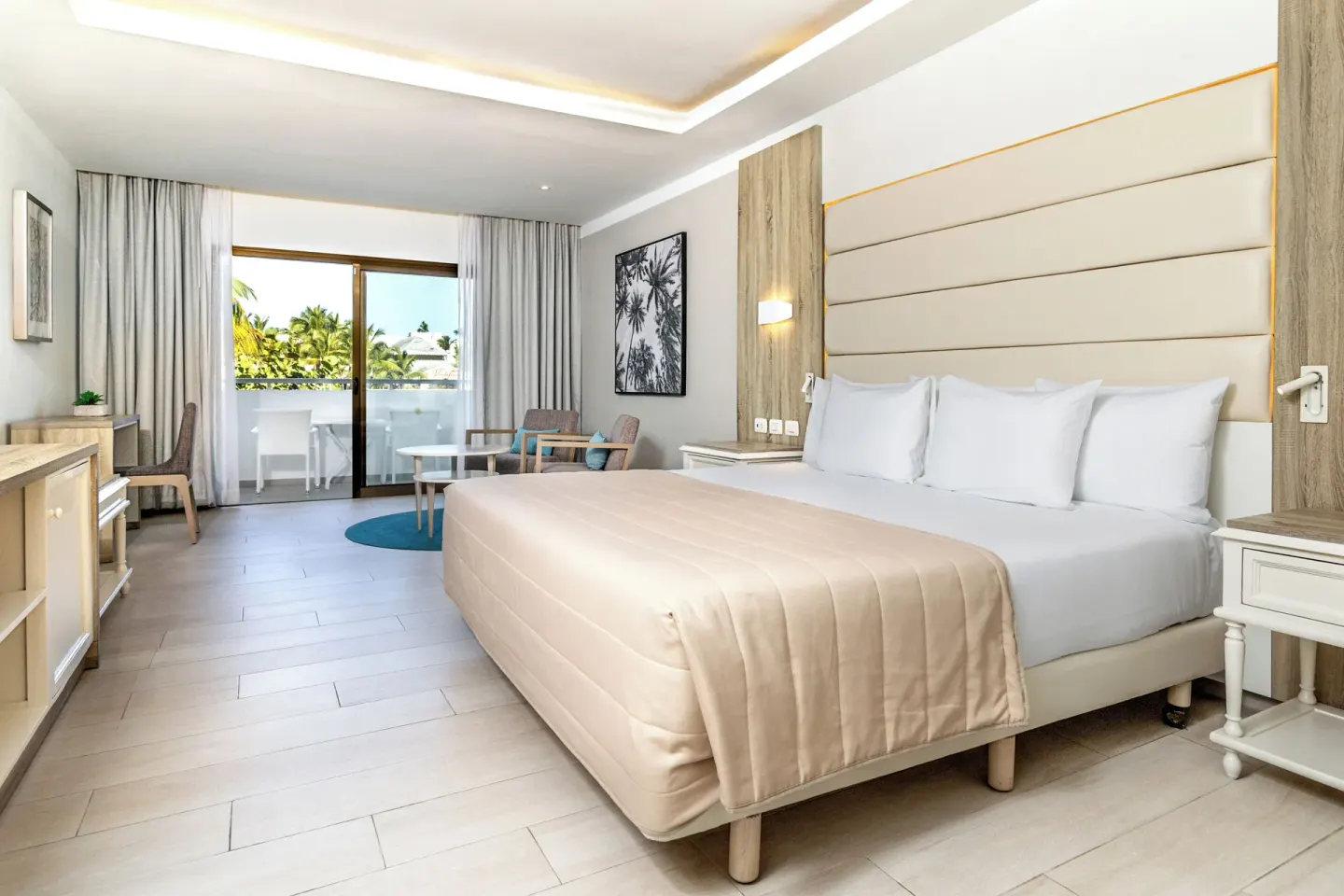 Junior Suite deluxe king bed with balcony doors at Bahia Principe Escape Ambar.