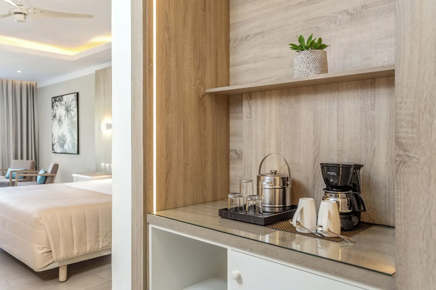 Junior Suite deluxe coffee station beside the bed at Bahia Principe Escape Ambar.