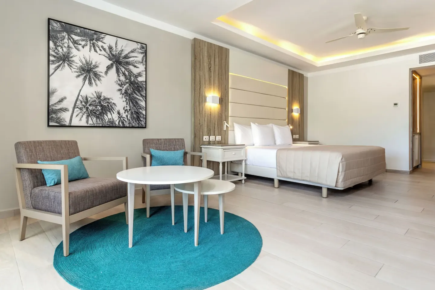 Junior Suite deluxe seating area and bed at Bahia Principe Escape Ambar.