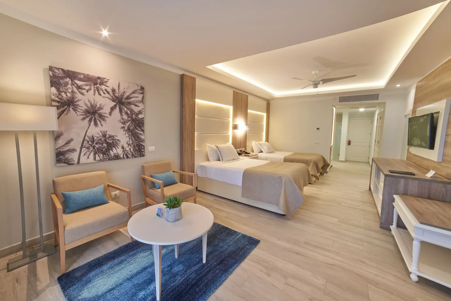 Junior Suite Deluxe with two beds and sitting area at Bahia Principe Escape Ambar.