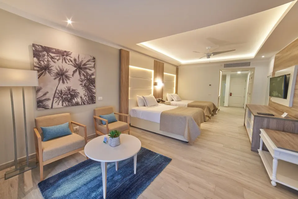 Junior Suite Deluxe with two beds and sitting area at Bahia Principe Escape Ambar.