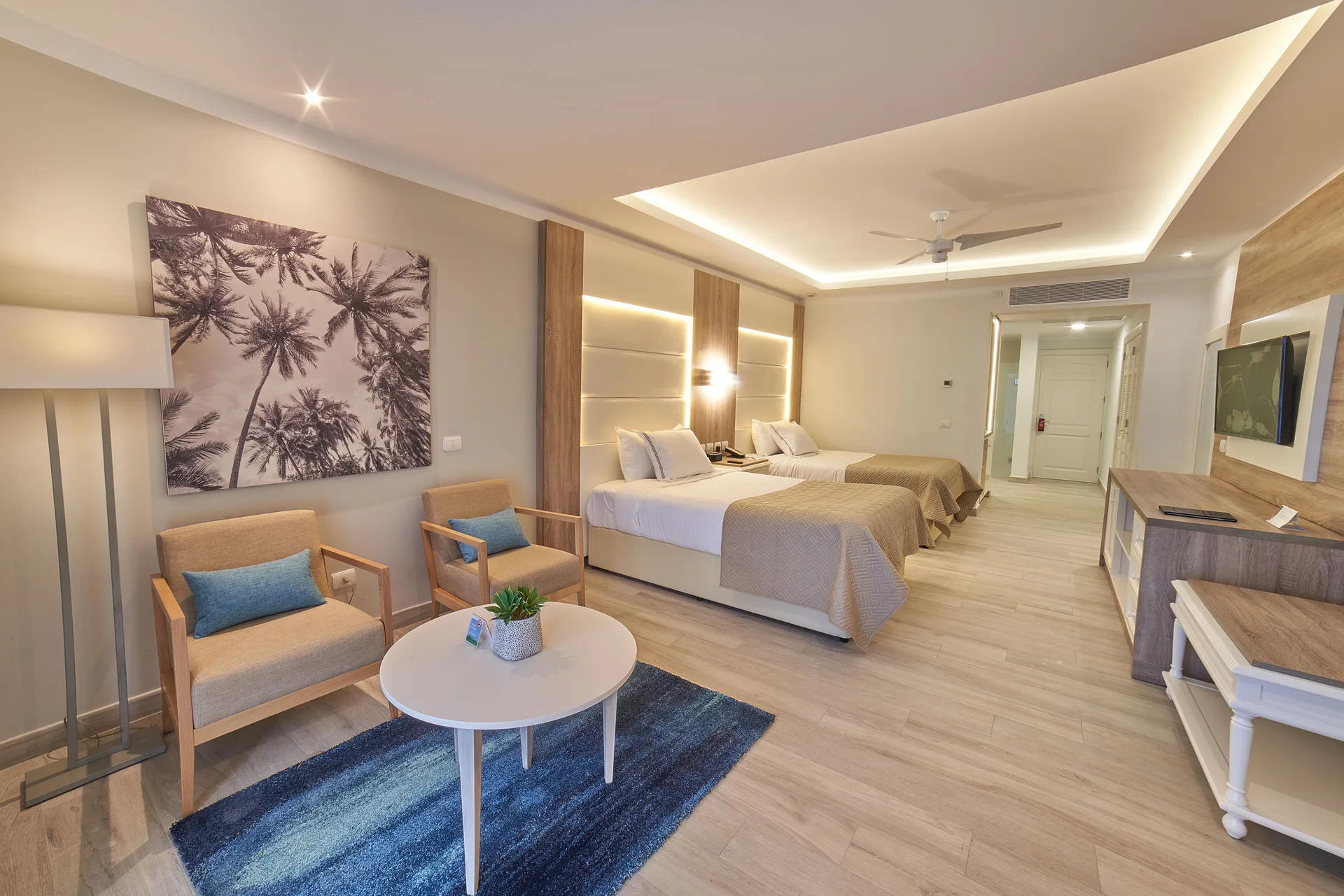 Junior Suite Deluxe with two beds and sitting area at Bahia Principe Escape Ambar.