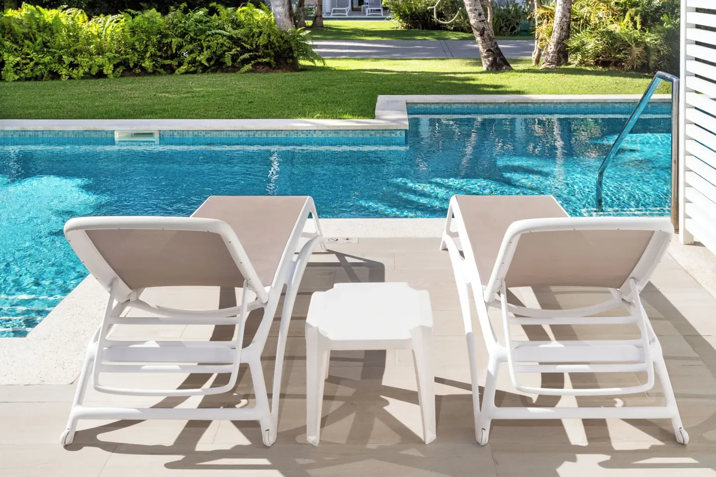 Junior Suite Swim Up patio with two loungers facing the pool at Bahia Principe Escape Ambar.