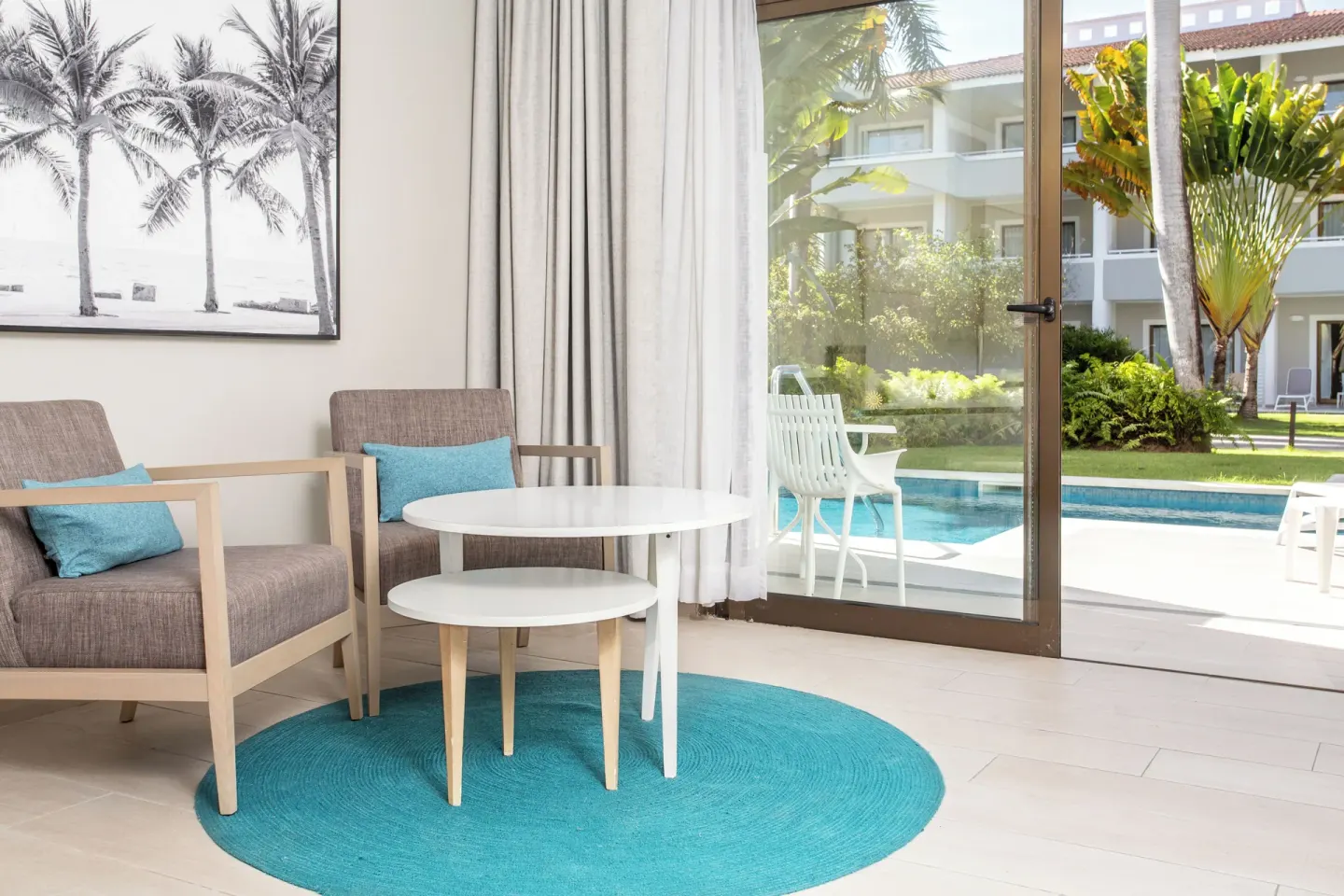 Junior Suite sitting area beside sliding doors to the swim-up pool at Bahia Principe Escape Ambar.