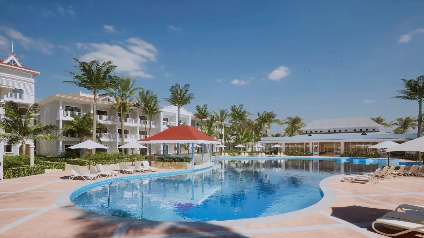 Curved pool beside white guest buildings at Bahia Principe Explore Esmeralda.