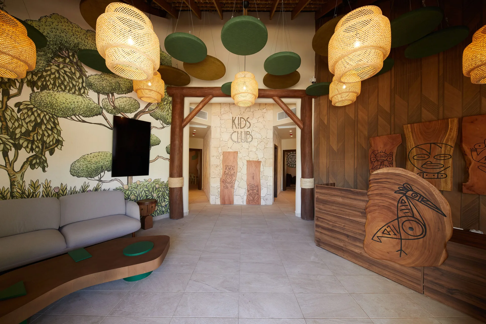 Kids club entrance with murals and woven pendant lights at Bahia Principe Explore Esmeralda.