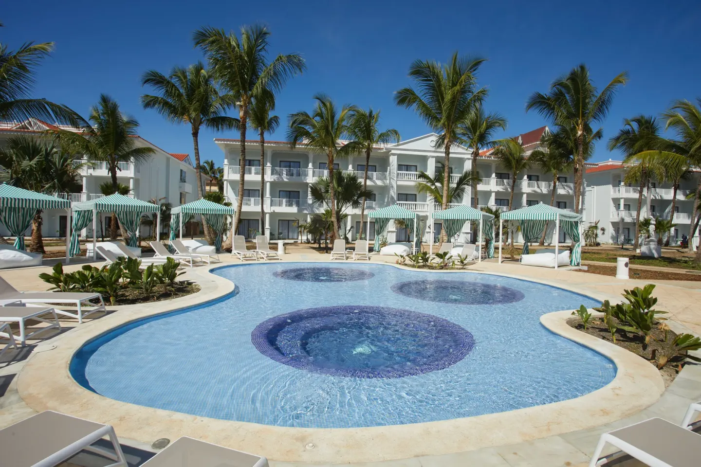 Small palm-lined pool with circular tile features at Bahia Principe Explore Esmeralda.