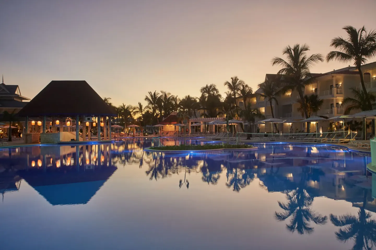 Twilight pool with palm reflections at Bahia Principe Explore Esmeralda.