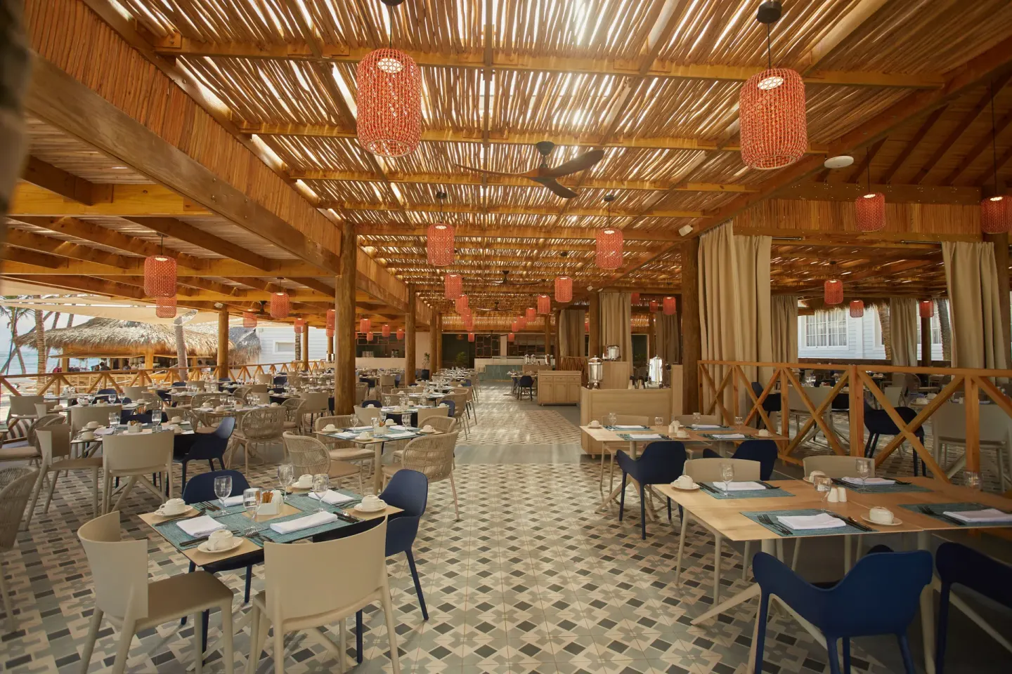 Open-air buffet dining room with wooden ceiling at Bahia Principe Explore Esmeralda.