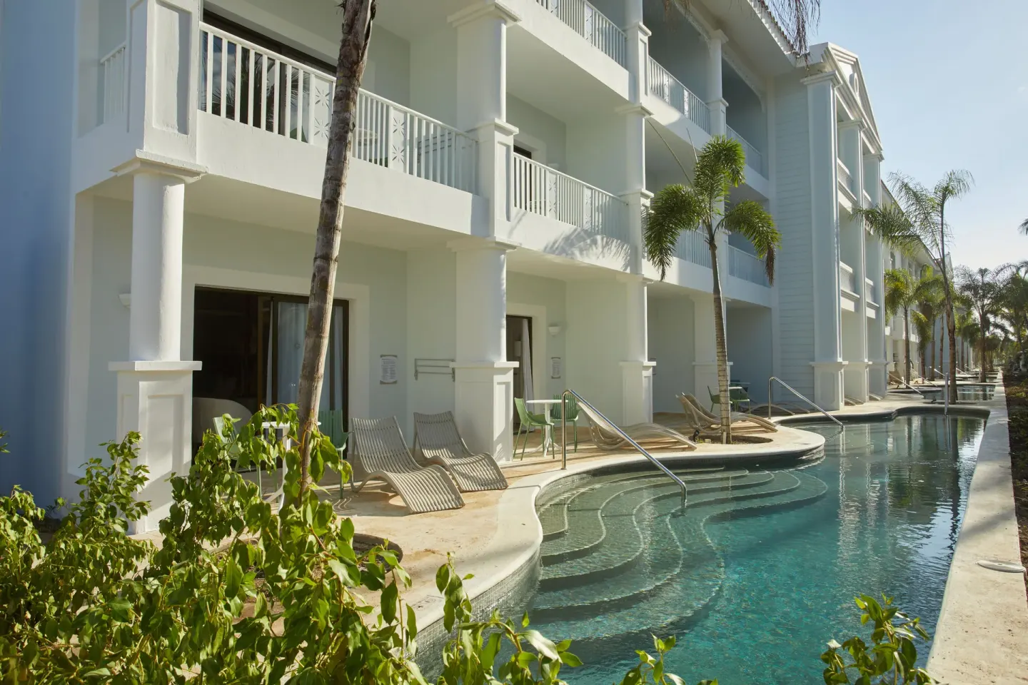 Swim-up Junior Suite terraces at Bahia Principe Explore Esmeralda run along a narrow pool channel.