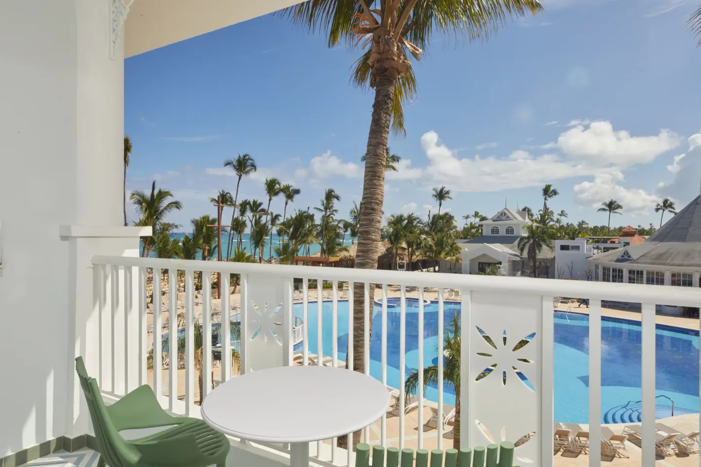 Junior Suite Deluxe balcony with pool and palm views at Bahia Principe Explore Esmeralda.