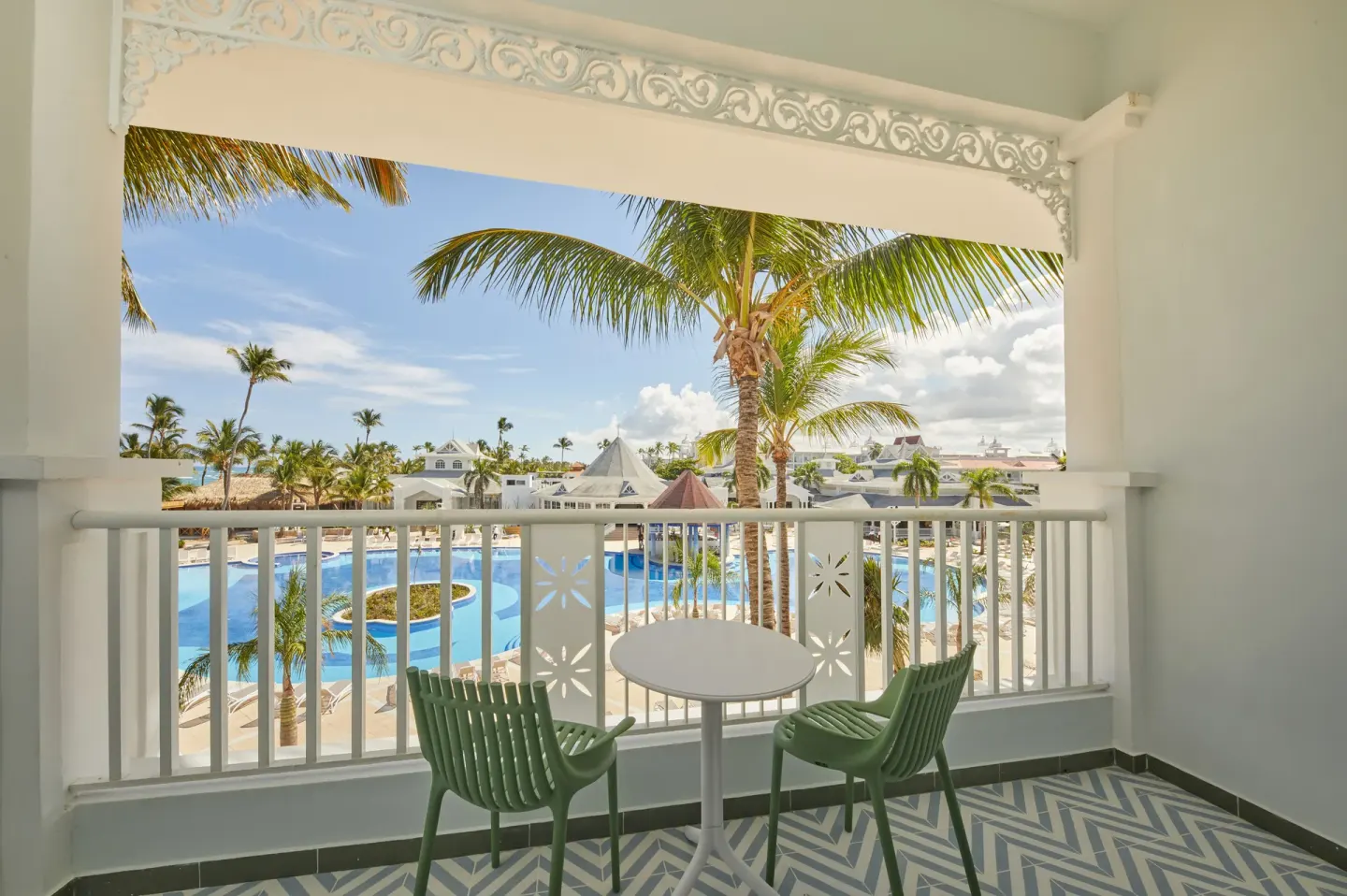 Junior Suite Deluxe balcony with pool and palm views at Bahia Principe Explore Esmeralda.