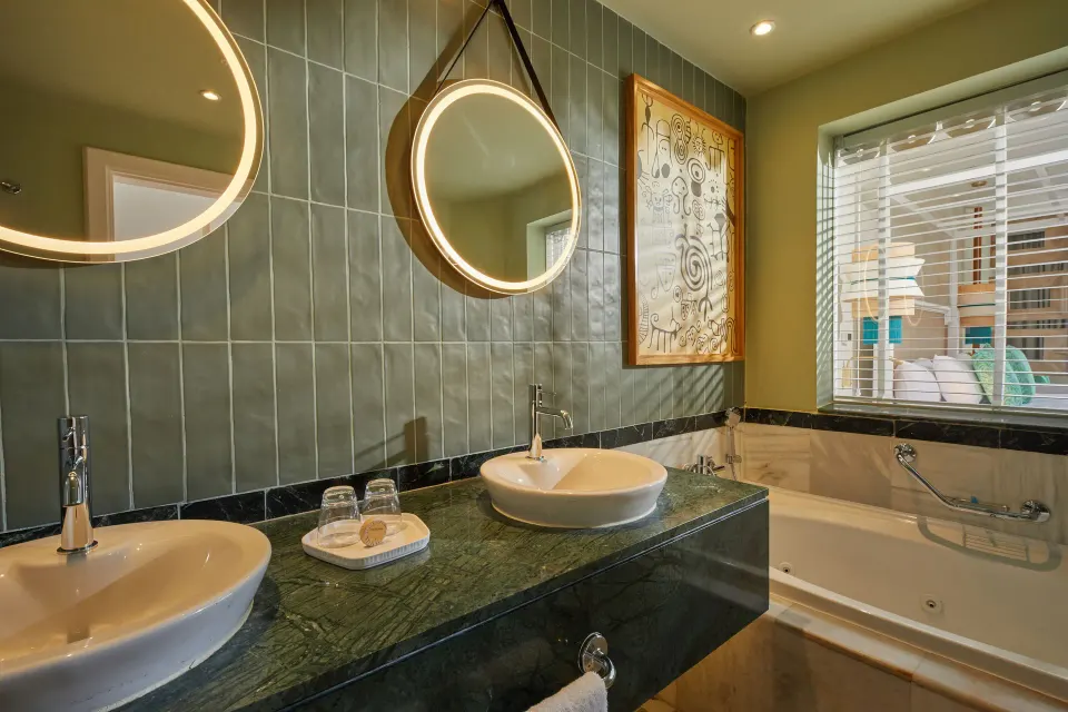 Junior Suite Deluxe bathroom with double sinks and bathtub at Bahia Principe Explore Esmeralda.