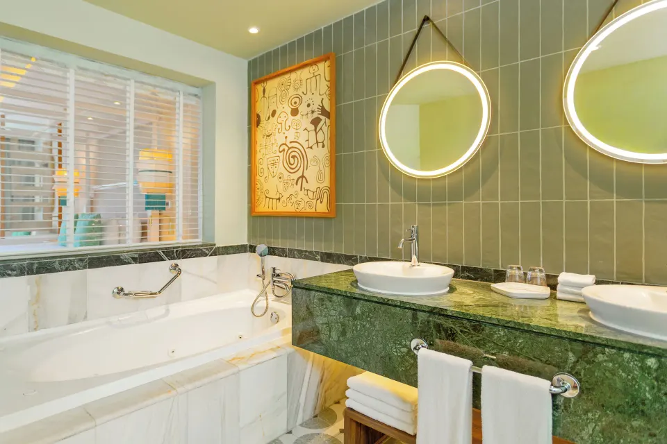 Junior Suite Deluxe bathroom with tub and double vanity at Bahia Principe Explore Esmeralda.