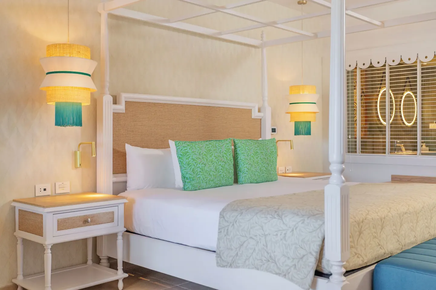 Junior Suite Deluxe canopy bed with bedside lamps at Bahia Principe Explore Esmeralda.