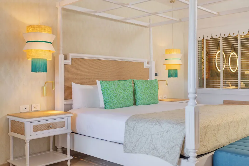 Junior Suite Deluxe canopy bed with bedside lamps at Bahia Principe Explore Esmeralda.