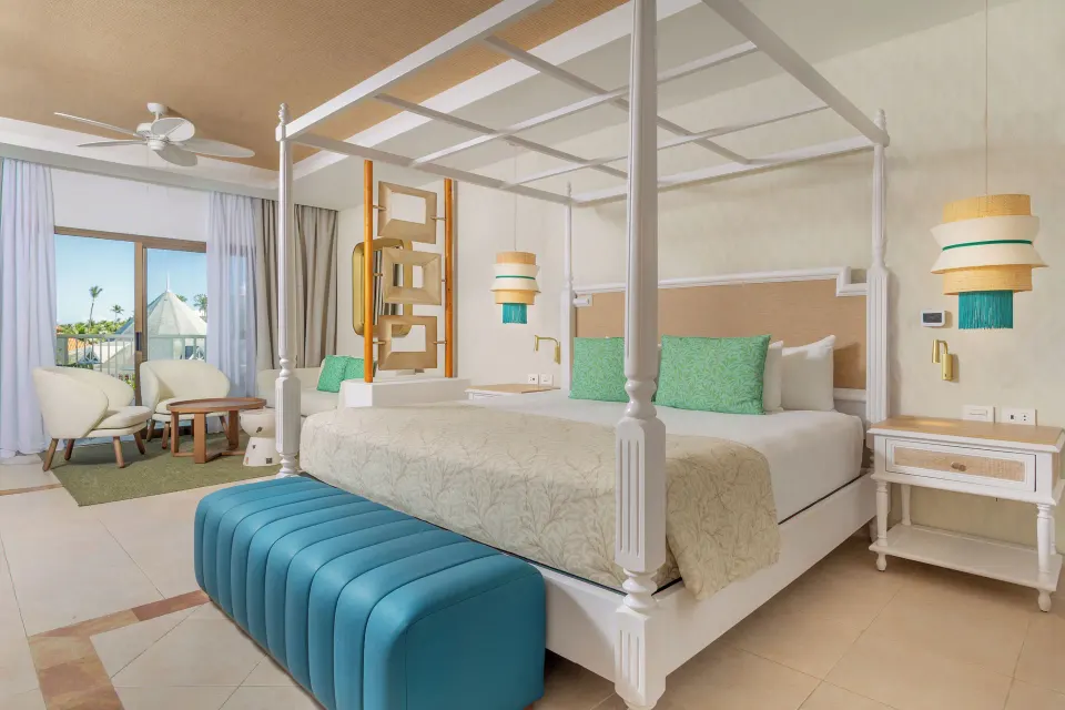 Junior Suite Deluxe canopy bed and sitting area at Bahia Principe Explore Esmeralda.