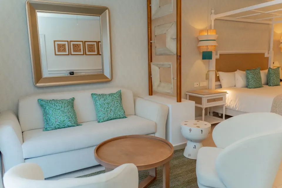 Junior Suite Deluxe sitting area and king bed at Bahia Principe Explore Esmeralda.