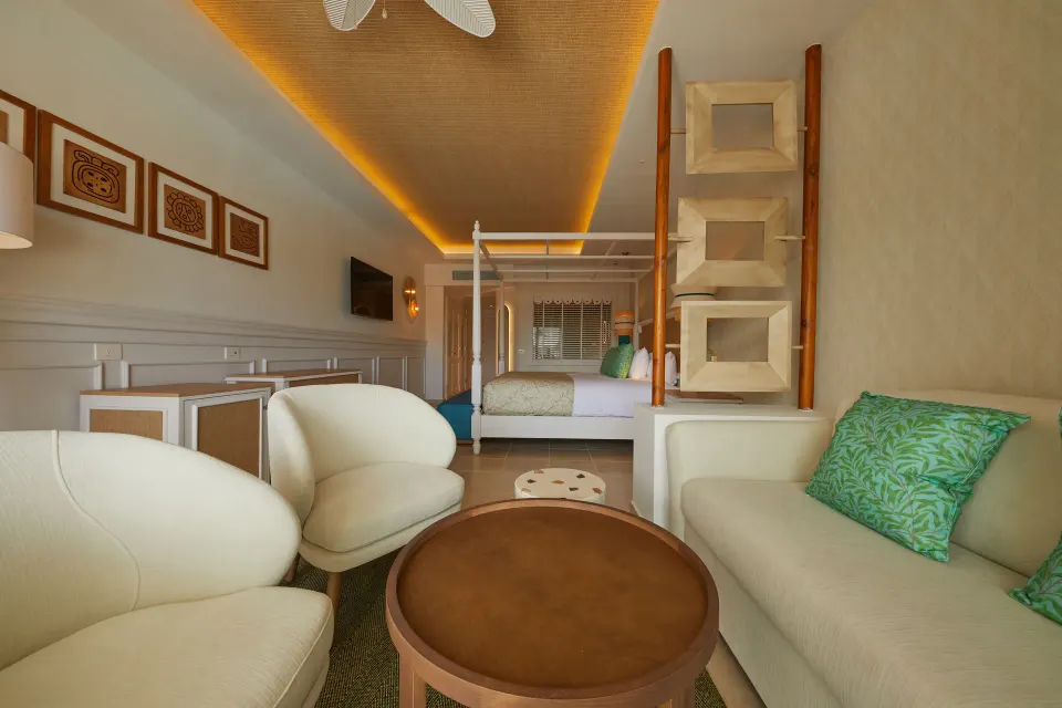 Junior Suite Deluxe lounge looking toward the king bed at Bahia Principe Explore Esmeralda.