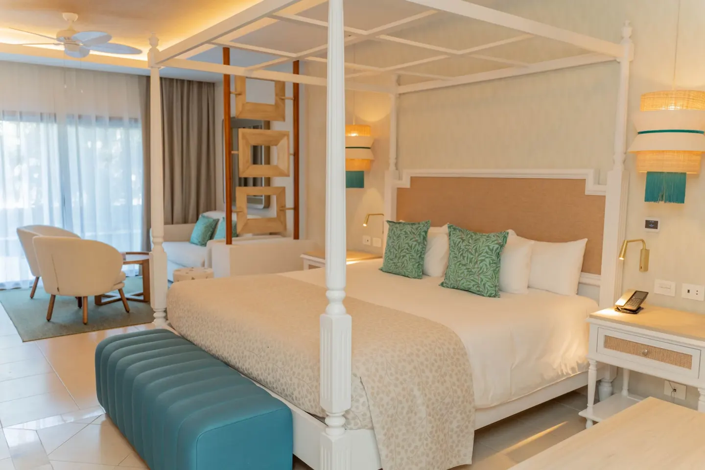 Junior Suite Deluxe king bed beside the sitting area at Bahia Principe Explore Esmeralda.