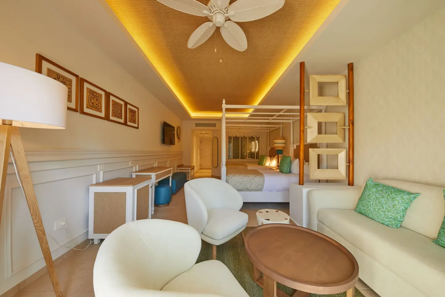 Junior Suite Deluxe sitting area with king bed beyond at Bahia Principe Explore Esmeralda.