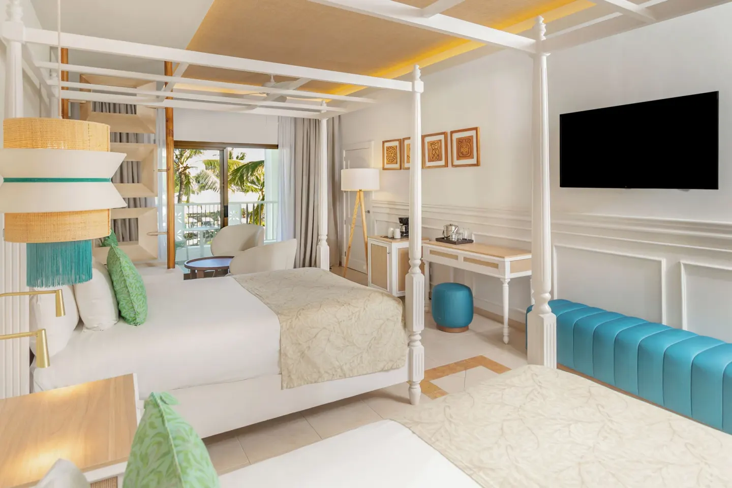 Junior Suite Deluxe with canopy beds, TV, and balcony at Bahia Principe Explore Esmeralda.