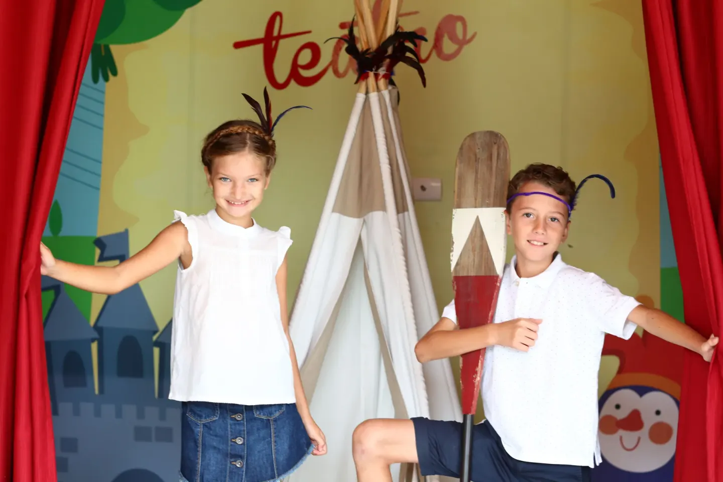 Children pose on a small theater stage at Bahia Principe Explore Legend.