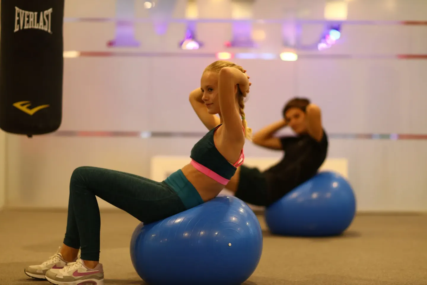 Guests do exercise ball crunches in the gym at Bahia Principe Explore Legend.
