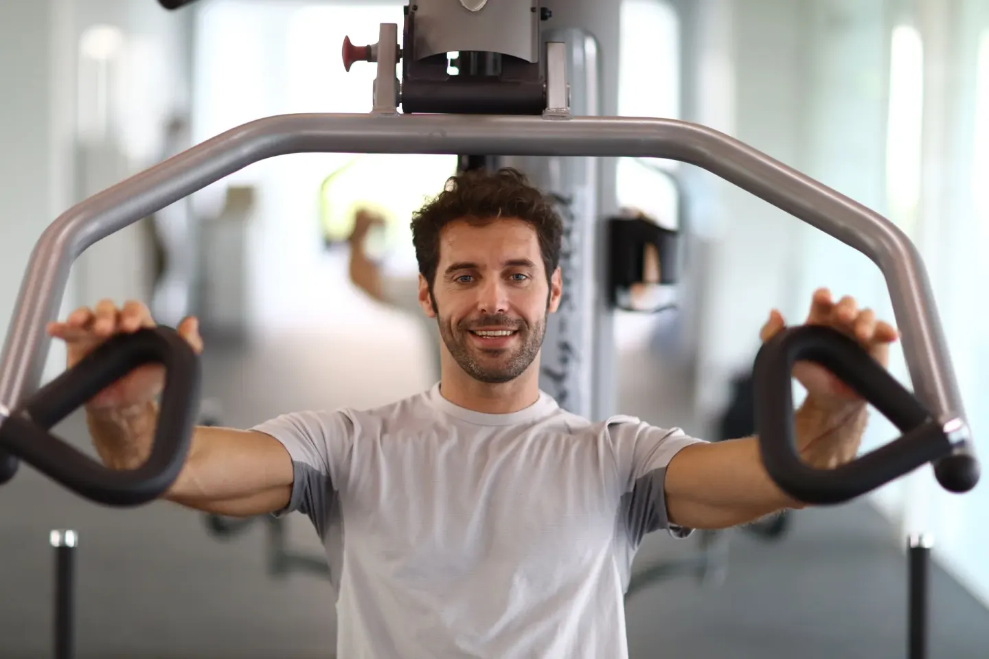 A guest uses a strength machine in the fitness room at Bahia Principe Explore Legend.