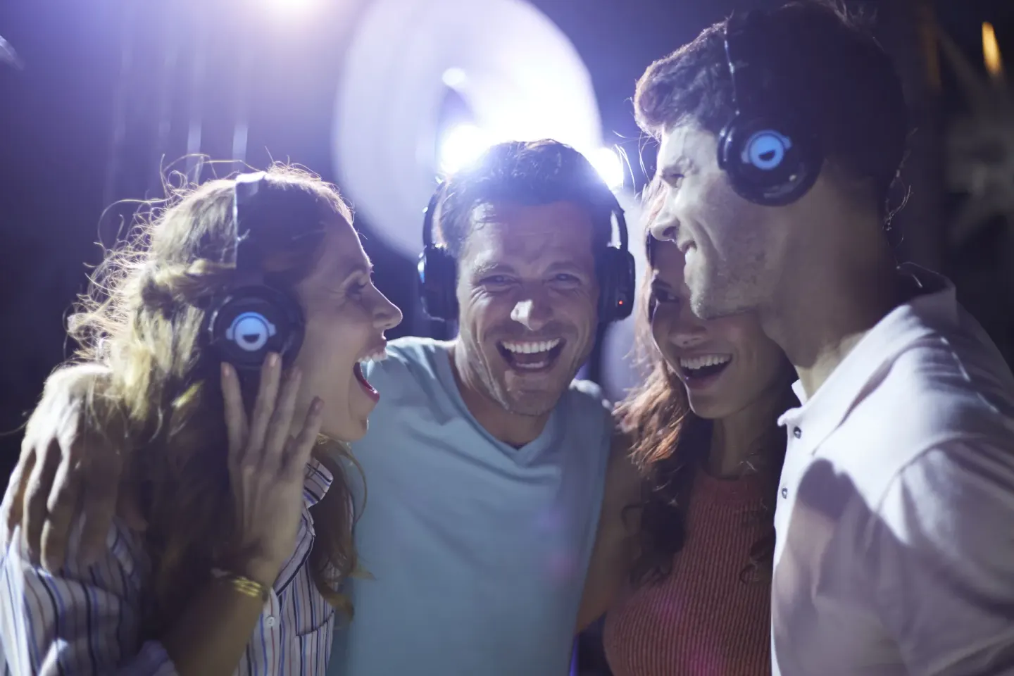 Guests wearing headphones gather at a night activity at Bahia Principe Explore Legend.