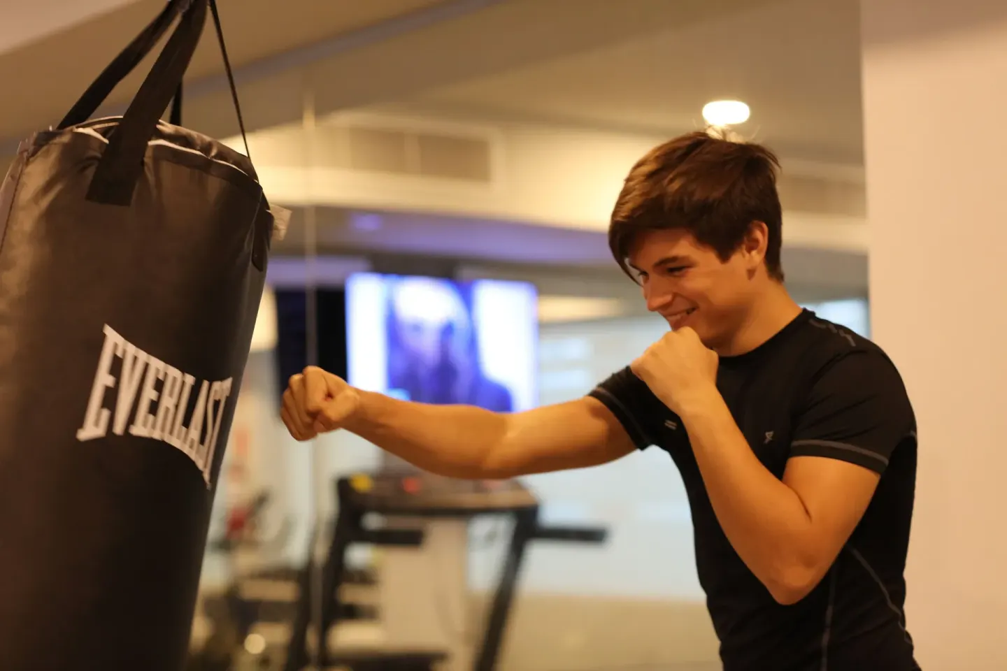A guest punches a heavy bag in the gym at Bahia Principe Explore Legend.