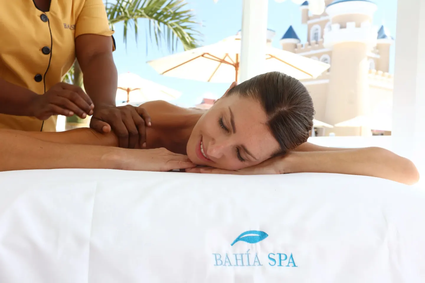 A guest receives a massage on a spa table at Bahia Principe Explore Legend.