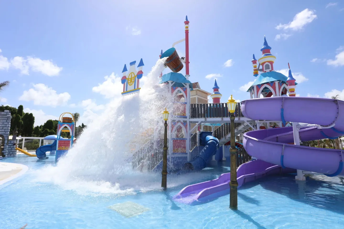 A tipping bucket splashes water over slides at Bahia Principe Explore Legend.