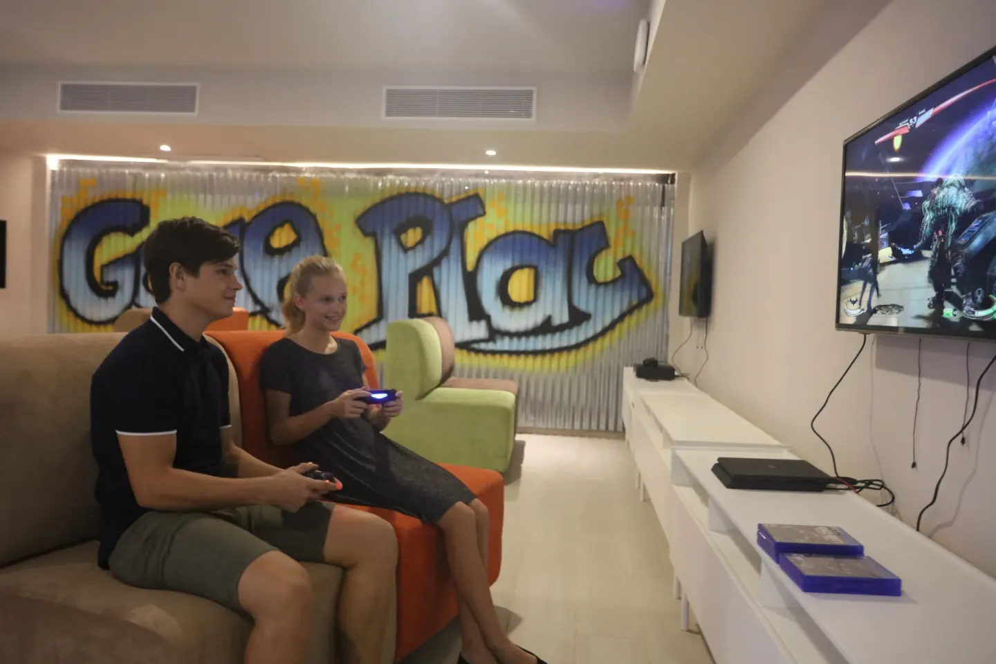 Guests play video games in a lounge at Bahia Principe Explore Legend.