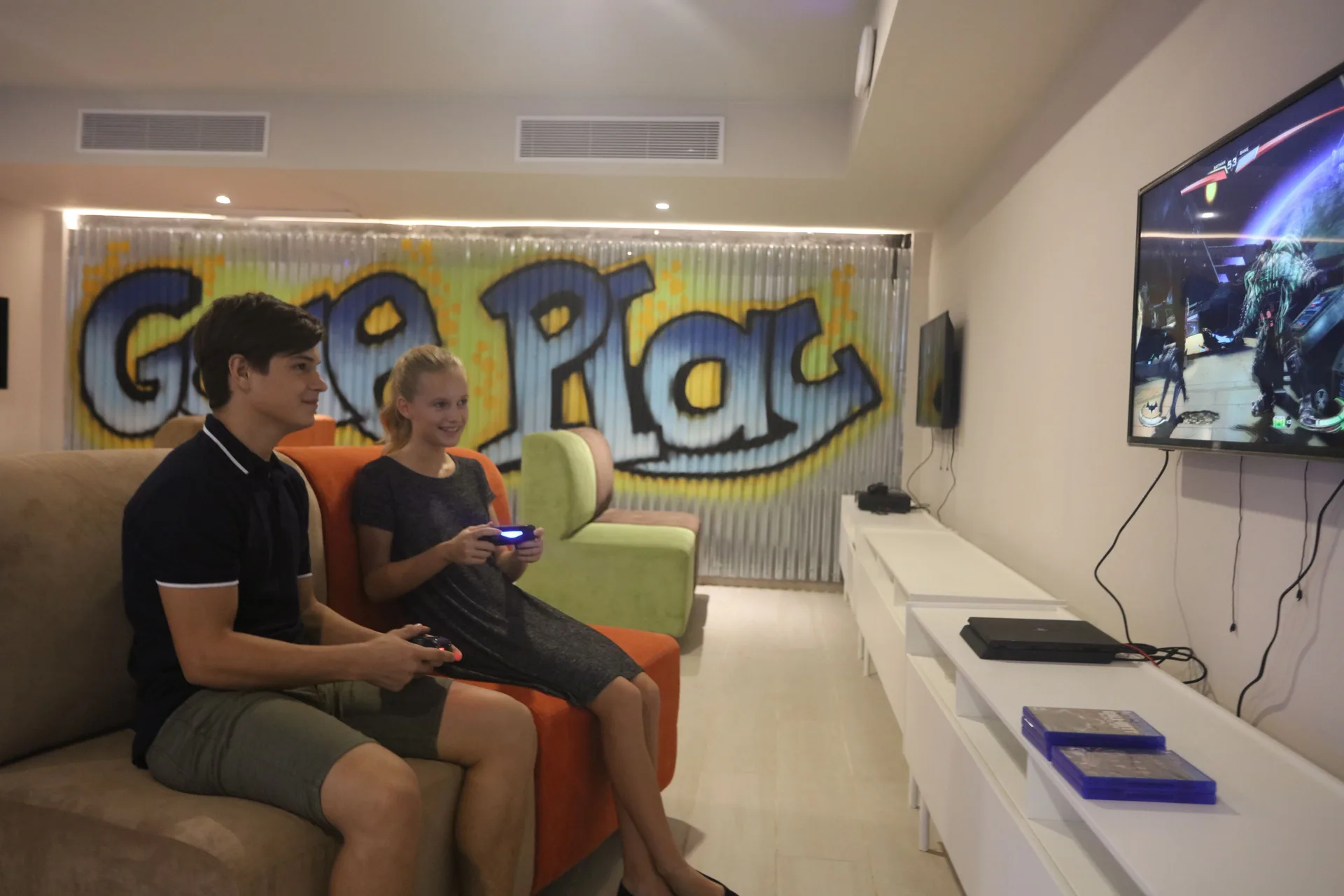 Guests play video games in a lounge at Bahia Principe Explore Legend.