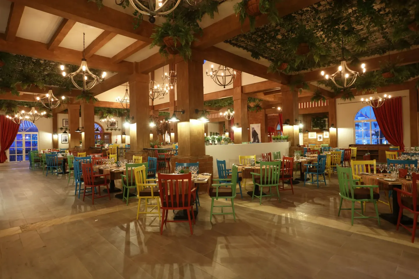 Colorful restaurant dining room with set tables at Bahia Principe Explore Legend.