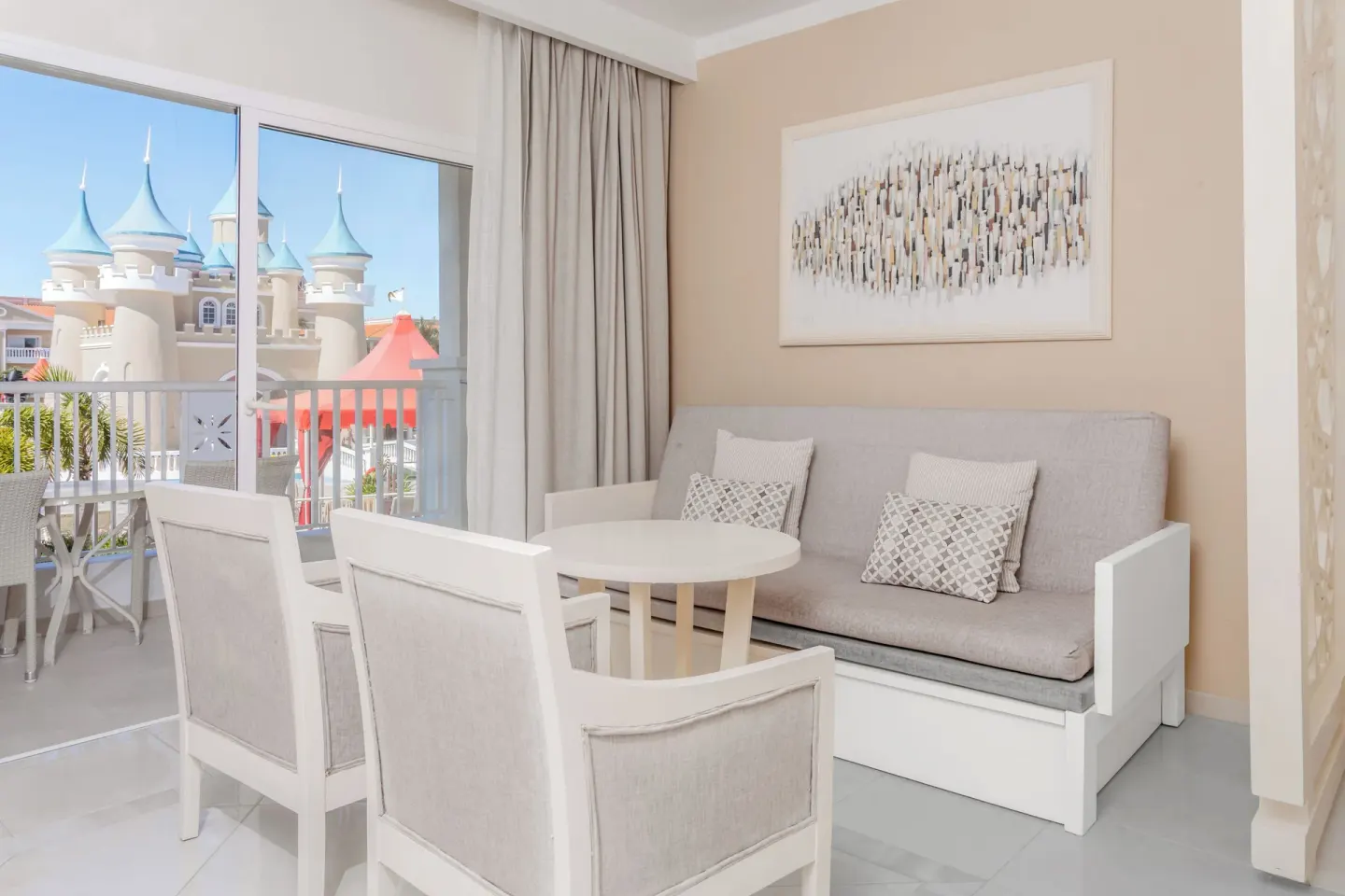 Junior Suite Castle View sofa and balcony view at Bahia Principe Explore Legend.