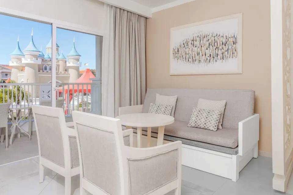 Junior Suite Castle View sofa and balcony view at Bahia Principe Explore Legend.