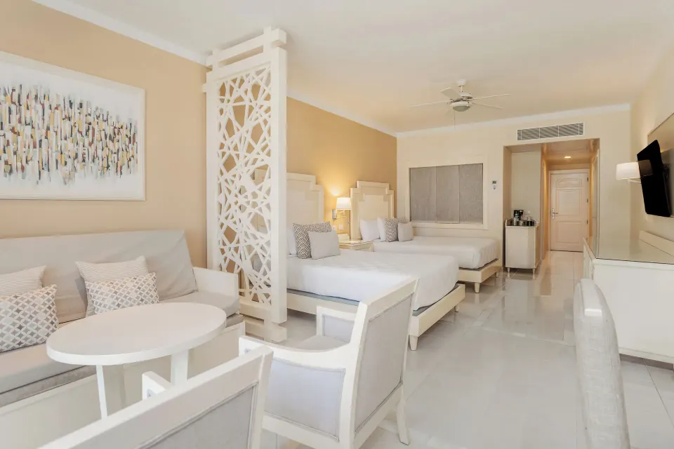 Junior Suite Castle View with twin beds and sitting area at Bahia Principe Explore Legend.