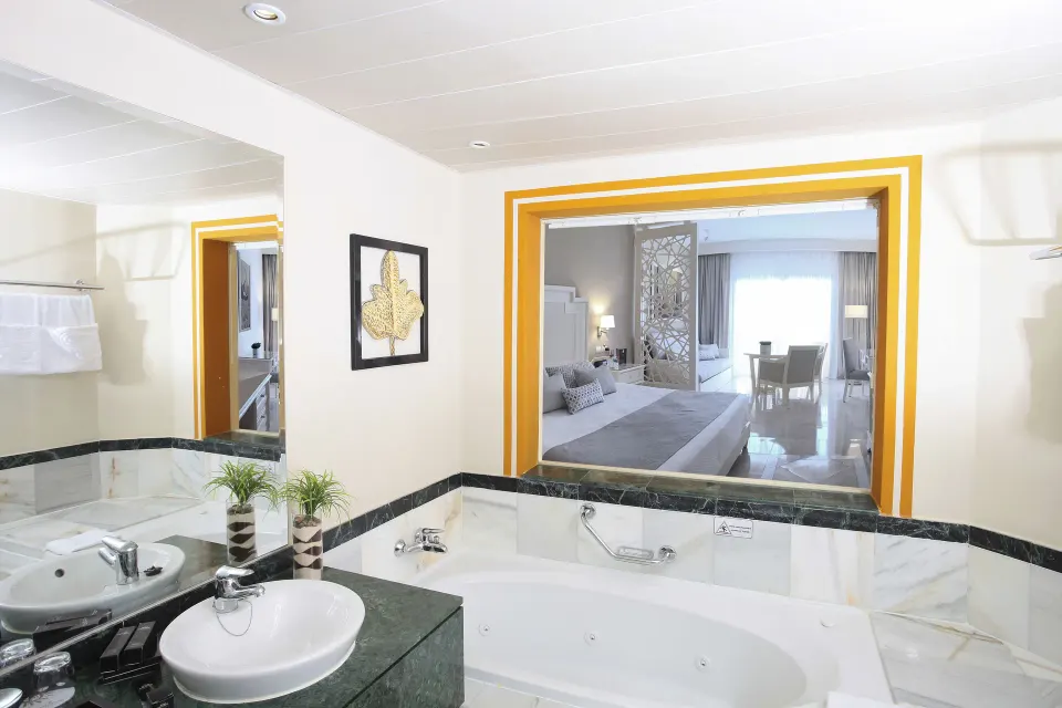 Junior Suite Deluxe bathroom with tub and sink at Bahia Principe Explore Legend.