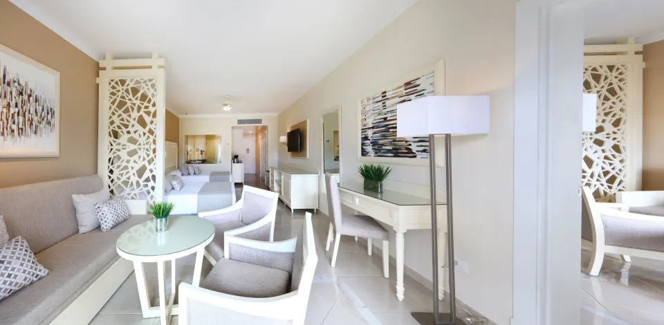 Junior Suite Deluxe sitting area and beds at Bahia Principe Explore Legend.
