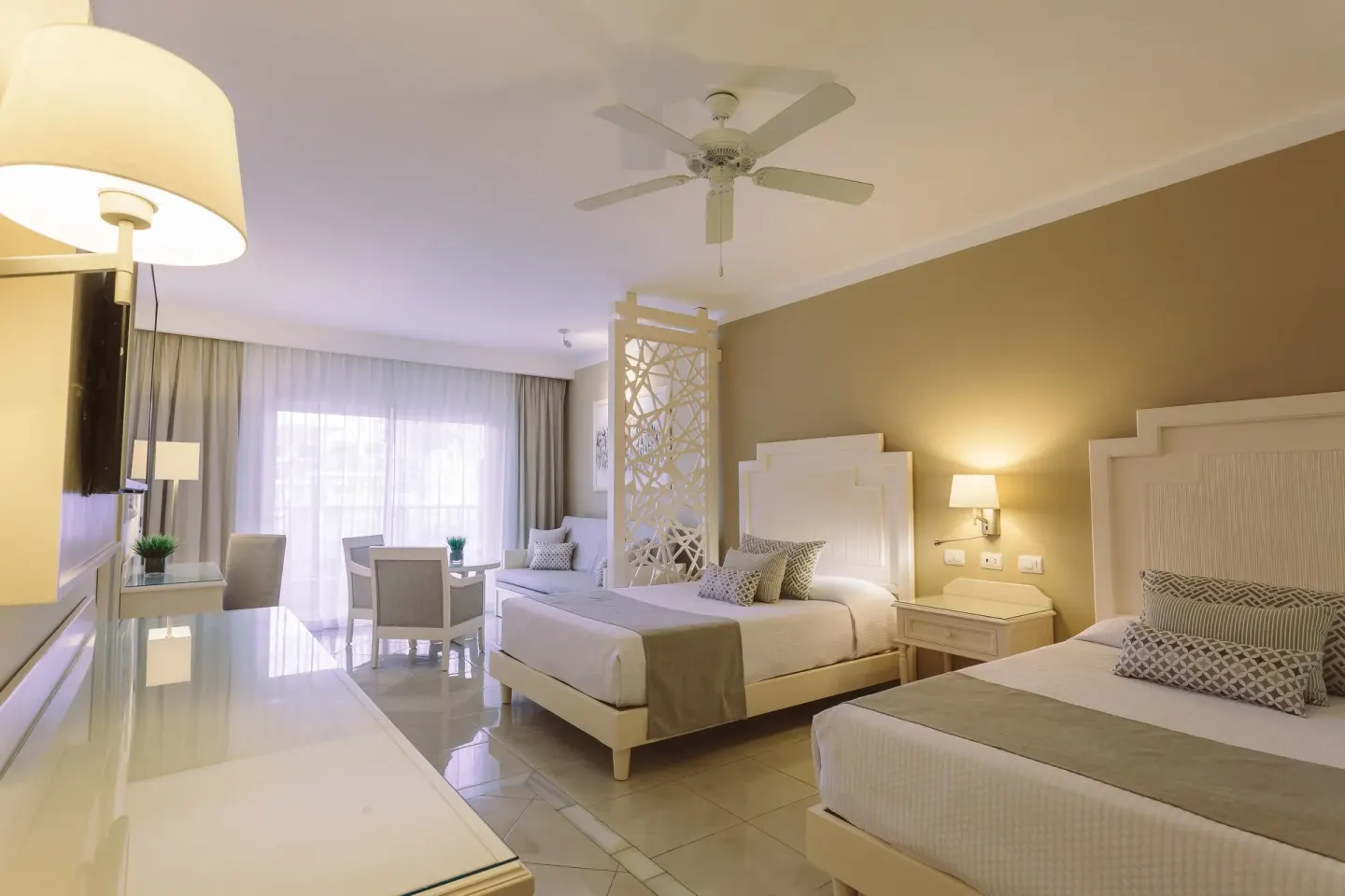 Junior Suite Deluxe with two beds and sitting area at Bahia Principe Explore Legend.