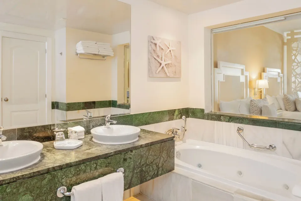 Junior Suite bathroom with tub and double vanity at Bahia Principe Explore Legend.