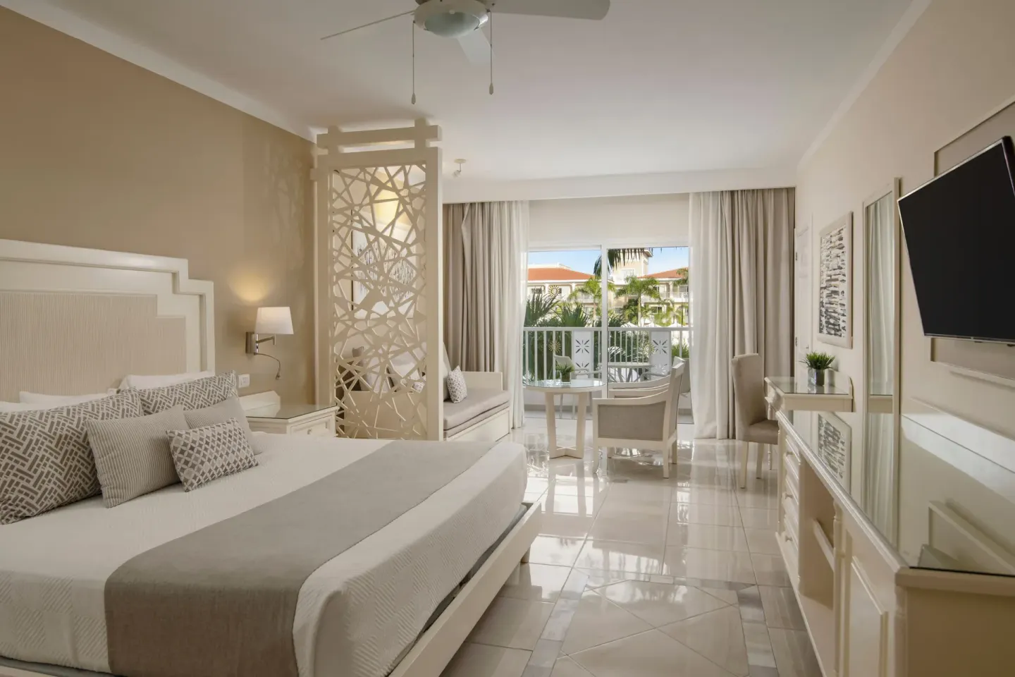 Junior Suite king bed and balcony area at Bahia Principe Explore Legend.