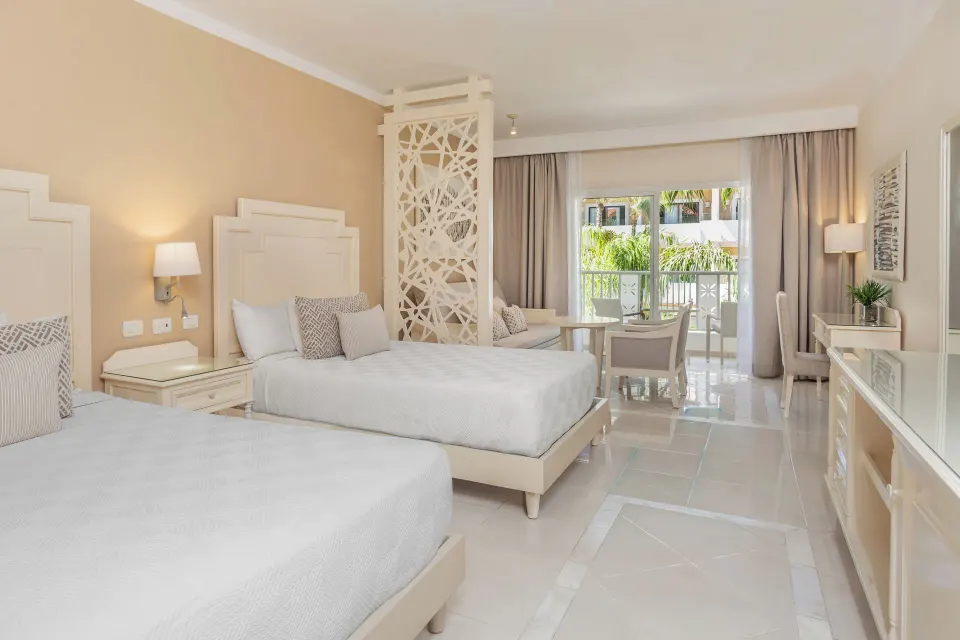 Junior Suite with two beds and balcony doors at Bahia Principe Explore Legend.